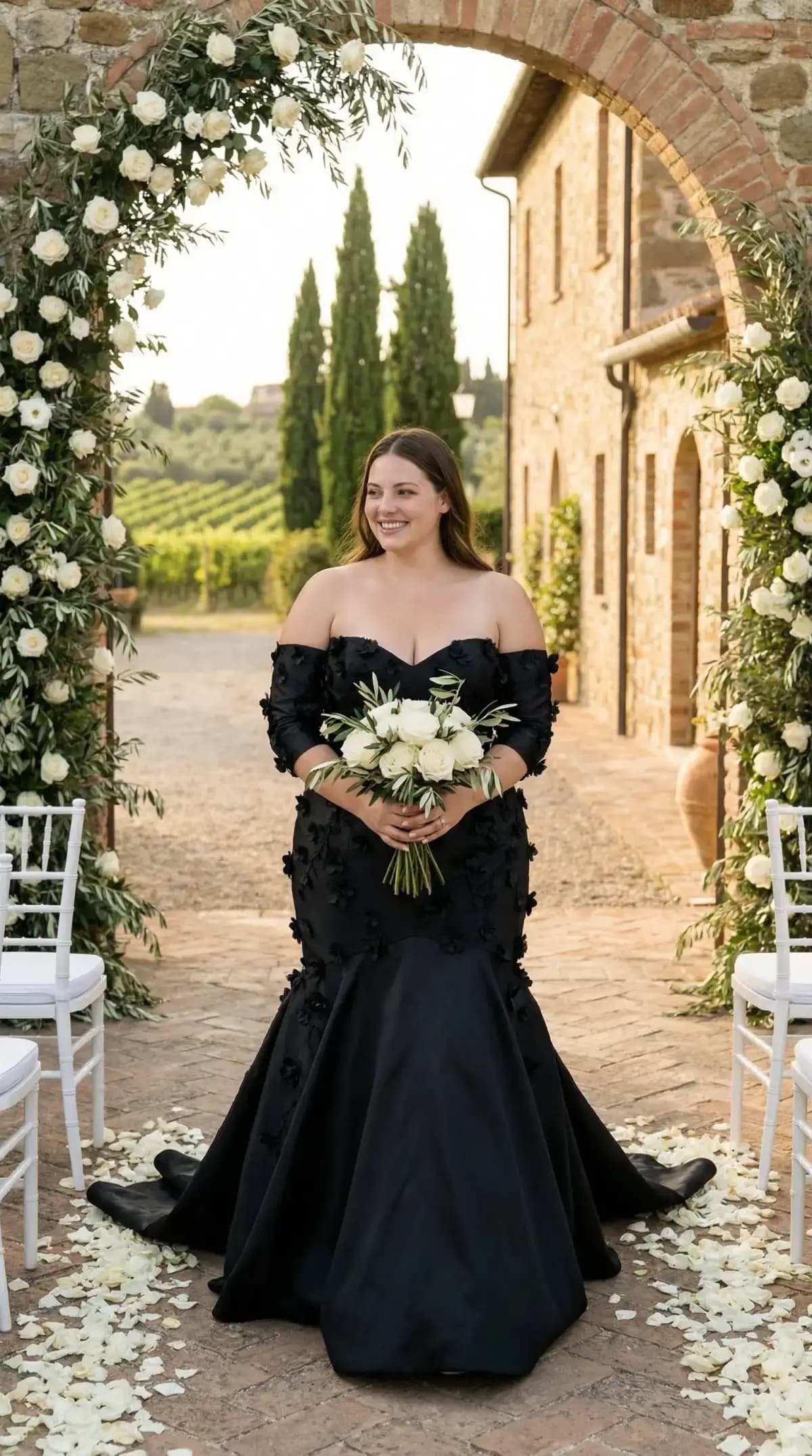 Black mermaid gown with floral applique at Tuscan arch