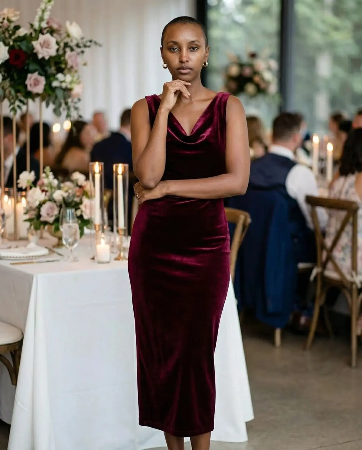 Deep burgundy velvet midi dress at a formal candlelit evening wedding reception